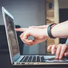 Hands pointing at laptop screen during testing
