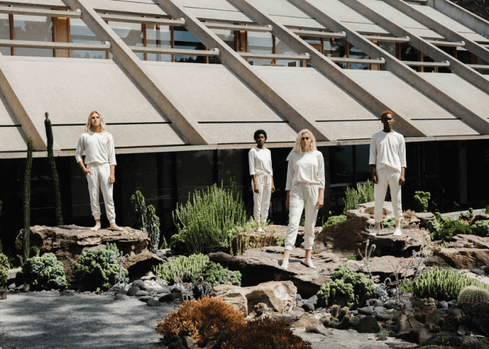 Four Models in White Clothes from Harvest And Mill Standing on Rocks