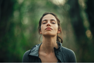 Woman breaths in the forest