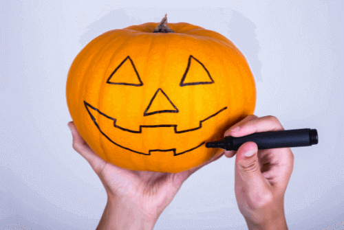Ein Halloween Kürbis auf dem eine gruselige Fratze gezeichnet wurde
