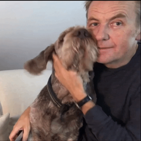 pet lover dad, a man smiling and petting his dog GIF